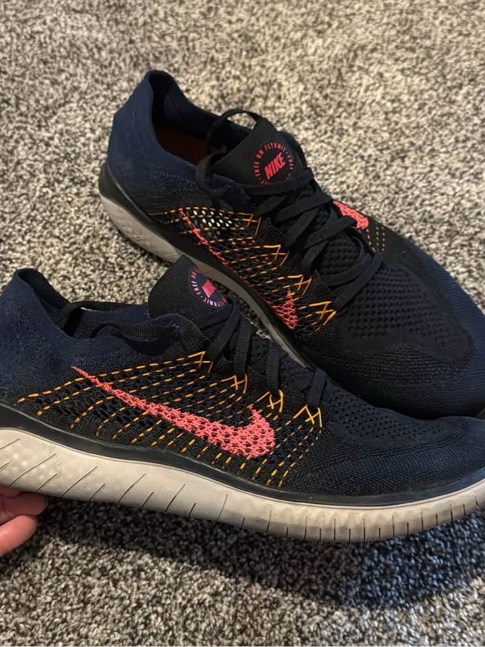Nike Black Flyknit Sneakers with Pink & Orange Stitch Detailing